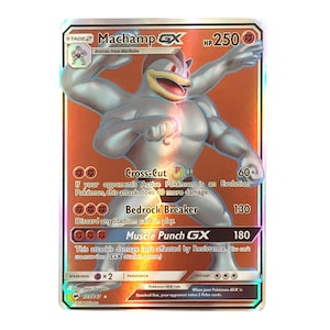 May include: A holographic Pokemon trading card featuring Machamp GX, a fighting type Pokemon with a silver body and blue eyes. The card has a red background with gold accents and the text "Machamp GX" in large, bold letters. The card also features the text "HP 250" and "Stage 2" in the top right corner.