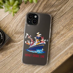 May include: Clear phone case featuring a Disney Cruise Line design. The case displays Mickey Mouse, Minnie Mouse, Donald Duck, and Goofy on a blue and red cruise ship. The words "DISNEY CRUISE LINE" are printed in red.