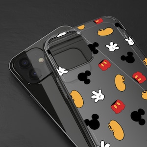 May include: A clear phone case featuring a Mickey Mouse design. The case has Mickey Mouse's head, hands, and shoes in black, red, and yellow on a transparent background.