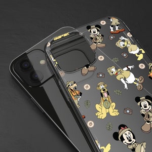 May include: Clear phone case with a pattern of Disney characters, including Mickey Mouse, Pluto, and Goofy, all dressed in safari outfits. The characters are surrounded by safari-themed elements like cameras, leaves, and a compass.