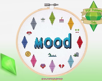 May include: A white embroidery hoop with the word "MOOD" in blue and green pixelated letters. The hoop is surrounded by a circle of colorful diamond-shaped icons, including a cake, a UFO, a heart, and a money bag. The text "PDF Pattern Only" is written on a green diamond-shaped ribbon.