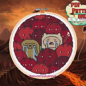 Pode incluir: Um padrão de ponto cruz em um bastidor de madeira apresenta personagens de desenhos animados chorando cercados por figuras vermelhas. O fundo mostra uma paisagem vulcânica. O texto diz "PDF Pattern Only" e "@sewnerdybybreigh".