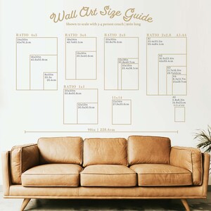 May include: A wall art size guide with dimensions in inches and centimeters, displayed above a brown leather couch. The guide includes various aspect ratios like 4x5, 3x4, and 2x3, with measurements such as 24x30in (61x76.2cm). The text reads "Wall Art Size Guide".