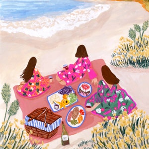 May include: Illustration of a beach picnic scene. Three figures in floral robes sit on a pink blanket, enjoying food and wine. A picnic basket, plates of food, and a bottle of wine are also present. The background shows the ocean and sand.