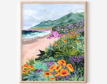 May include: A framed art print of a coastal landscape. The artwork depicts a beach with crashing waves, a sandy shore, and green mountains in the background. The foreground features vibrant orange and purple flowers.