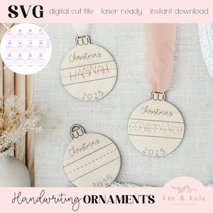 May include: Wooden Christmas ornaments with the names "Hannah" and "Constance" engraved, along with the year 2025. The ornaments have a handwritten style and are hanging with ribbons. The image also includes the text "Handwriting ORNAMENTS".