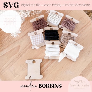 May include: Wooden bobbins with different colored threads and ribbons. The bobbins are arranged on a wooden surface. The text "wooden BOBBINS" is at the bottom of the image.