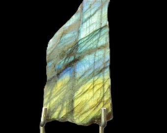 May include: A belt buckle featuring a polished, irregular slab of labradorite stone with iridescent blue and yellow flashes, set into a silver-toned metal frame. The number 9 is visible in the upper left corner of the image.