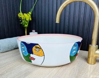 Caras únicas y coloridas del fregadero del recipiente del baño pintadas a mano en cerámica, lavabo minimalista del lavabo de la encimera del baño de lujo