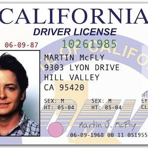 May include: California driver's license featuring Martin McFly, with an expiration date of 06-09-87. The license includes personal details such as address, height (5' 4"), and eye color (blue).