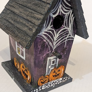 Halloween Birdhouse with spooky spider webs, jack o lanterns and bats to highlight your Halloween décor in a cute, non terrifying way