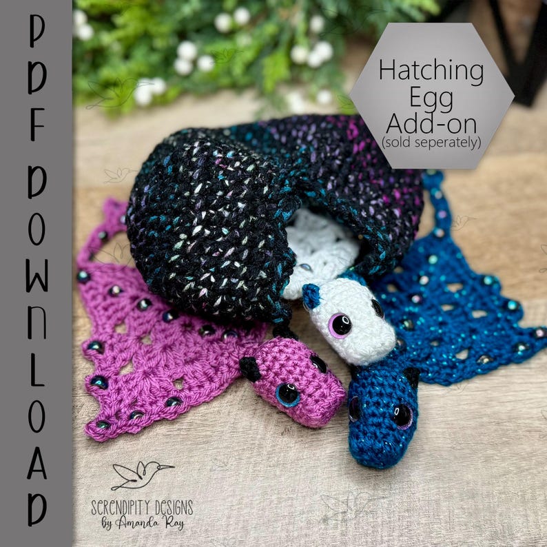 May include: A crocheted hatching egg add-on with three small, colorful creatures. The egg is black with flecks of color, and the creatures are pink, blue, and white, each with large eyes. A purple crocheted piece is on the left.