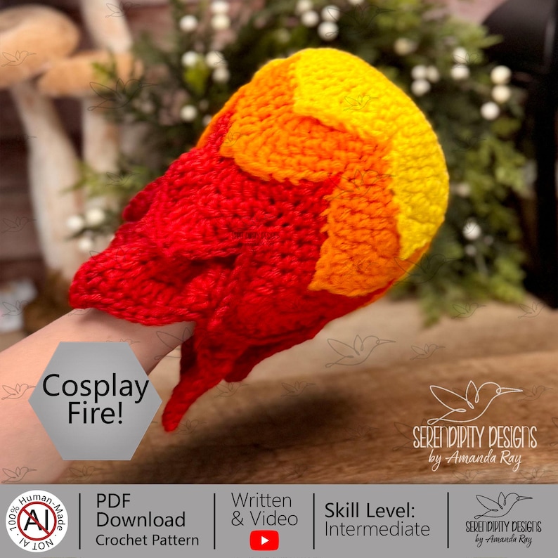 May include: A crochet fire prop featuring a gradient of red, orange, and yellow yarn. The flame-shaped accessory has a textured, hand-stitched appearance with pointed edges. A hexagonal label on the item displays the text Cosplay Fire!