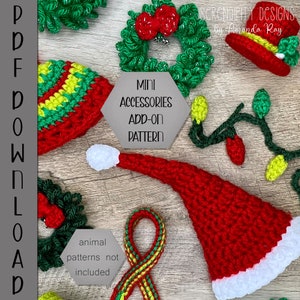 May include: A set of crochet Christmas mini accessories, including a wreath, a hat, a Santa hat, a string of lights, and a scarf. The text "MINI ACCESSORIES ADD-ON PATTERN" is on a gray hexagon. The text "animal patterns not included" is on a gray hexagon. The text "SCRENDIPITY DESIGNS by Amanda Ray" is at the top of the image.