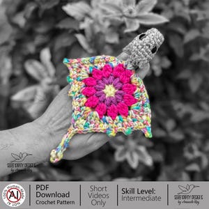 May include: A vibrant crochet square featuring a central flower motif in pink and purple, edged with yellow, blue, and green. A small grey crocheted figure is attached. The image includes text: "PDF Download Crochet Pattern" and "Skill Level: Intermediate."