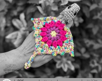 May include: A colorful crochet square with a central flower design in shades of pink and purple, surrounded by a border of yellow, blue, and green. A small gray crocheted figure is attached. The image includes text: "PDF Download Crochet Pattern" and "Skill Level: Intermediate."