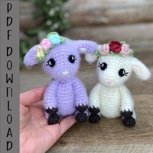 May include: Two crocheted lambs with floral headbands. One lamb is purple and the other is white.