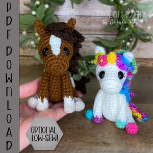 May include: Two crocheted stuffed animals, a brown and white horse and a white unicorn with a rainbow mane and tail. The unicorn has a pink, yellow, and blue flower crown. The animals are sitting on a wooden surface. The text "OPTIONAL LOW-SEW!" is visible in the image.