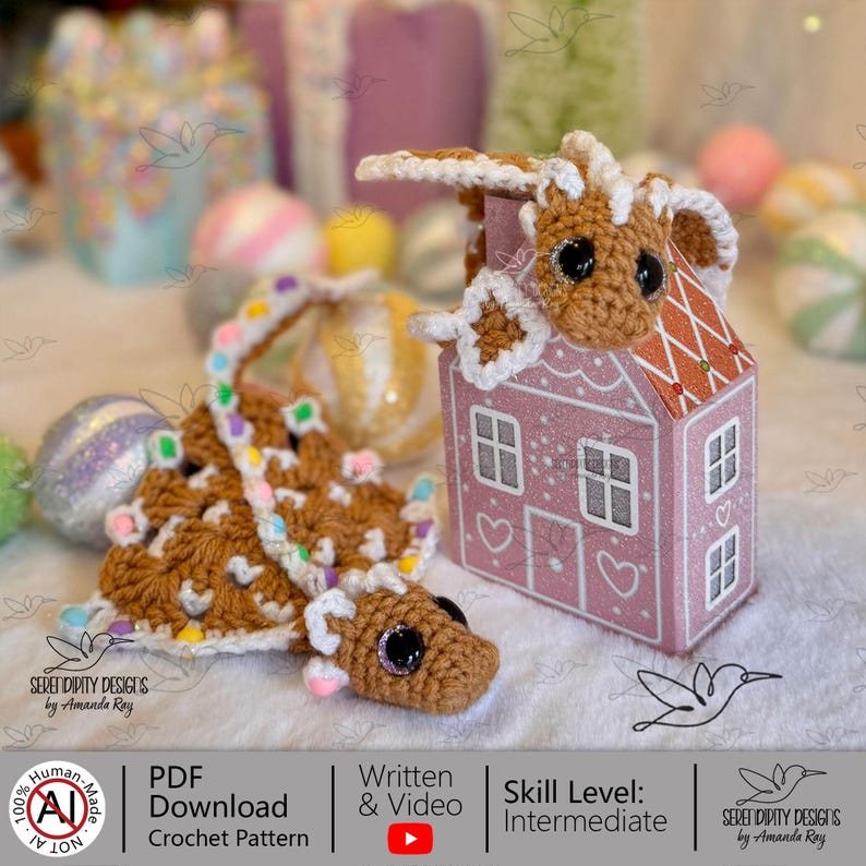 May include: A crocheted gingerbread dragon and house. The dragon is brown with white accents and colourful candy decorations. The pink house has white trim and heart details. The image includes text that says "PDF Download Crochet Pattern" and "Written & Video".