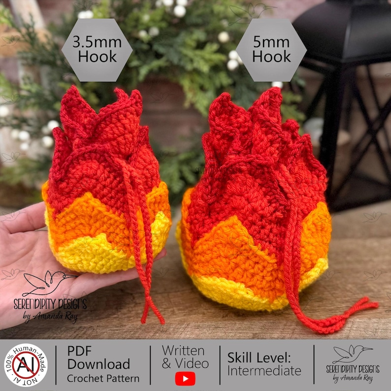 May include: Two flame-shaped crochet pouches in red, orange, and yellow yarn. The smaller pouch is labeled 3.5mm Hook and the larger pouch is labeled 5mm Hook. Both pouches feature a drawstring closure and textured, layered flame-like petals.