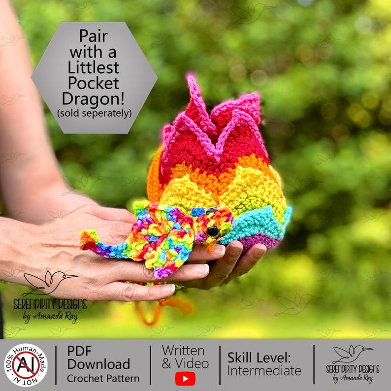 May include: A multi-colored crocheted dragon toy featuring a rainbow-patterned body with a jagged, red-topped spine. The text on the image reads: Pair with a Littlest Pocket Dragon! (sold seperately), Serendipity Designs by Amanda Ray, PDF Download Crochet Pattern, Written & Video, Skill Level: Intermediate.