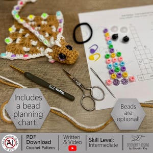 May include: A crochet pattern featuring a brown giraffe, crochet hook, scissors, and beads. The image includes a bead planning chart and the text "Beads are optional!" and "Includes a bead planning chart!"