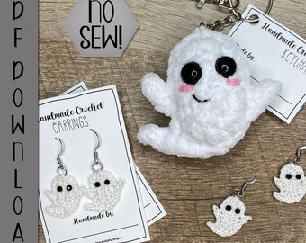 May include: White crocheted ghost keychain with black eyes and a pink blush. The keychain is attached to a silver key ring. The image also shows a pair of white crocheted ghost earrings and a sign that says "Handmade Crochet Keychains".