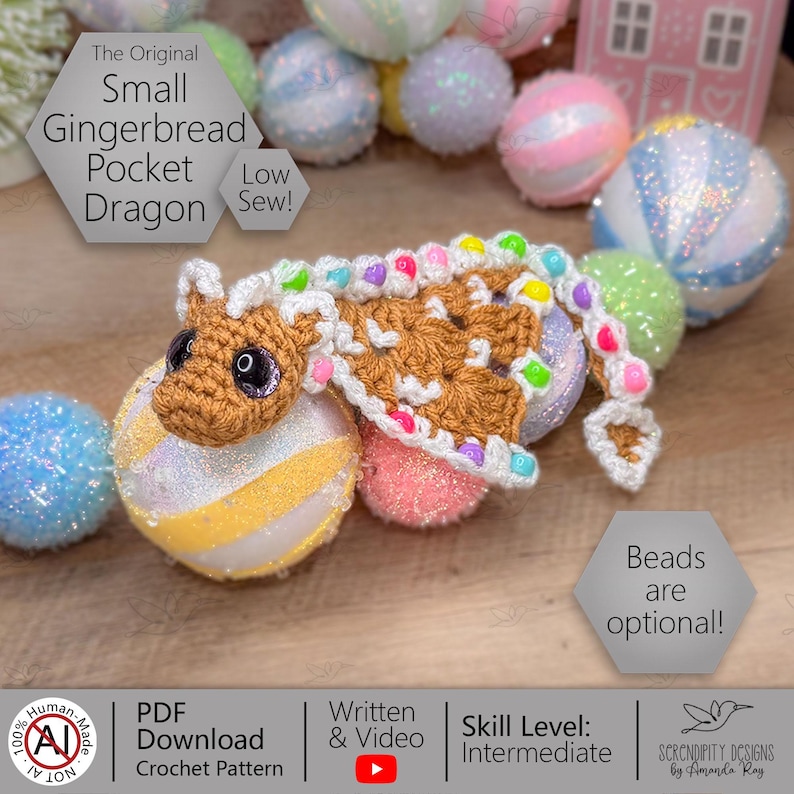 May include: A handmade crocheted gingerbread dragon with brown and white details, and colourful bead accents. The dragon is on a glittery ball. Text on the image reads "Small Gingerbread Pocket Dragon" and "Beads are optional!"