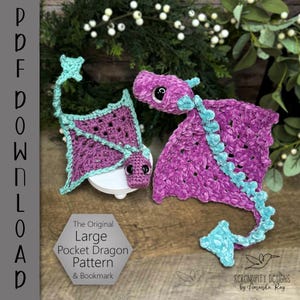 May include: Two crocheted dragons in shades of purple and teal. One is a large dragon with wings, and the other is a smaller dragon with a kite-like shape. The text on the image reads "The Original Large Pocket Dragon Pattern & Bookmark."