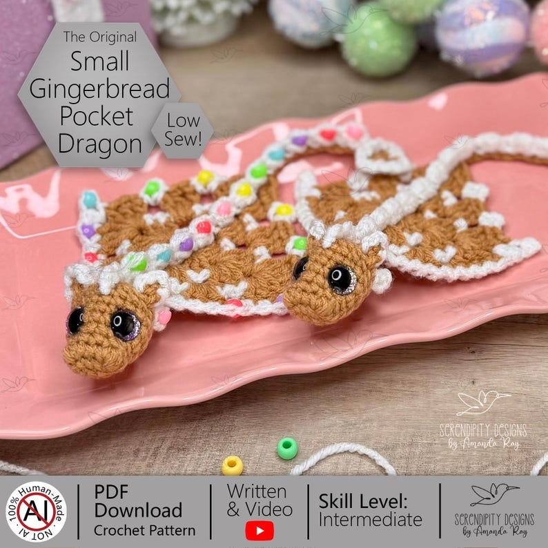 May include: Two crocheted gingerbread pocket dragons with white detailing and colourful bead accents are shown on a pink plate. The dragons have large, black eyes and are labelled "The Original Small Gingerbread Pocket Dragon". The crochet pattern is available as a PDF download.