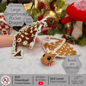 May include: A crocheted gingerbread dragon with brown and white details, accented with red and green. The text "The Original Large Gingerbread Pocket Dragon" is visible. The design includes optional beads. The skill level is intermediate.