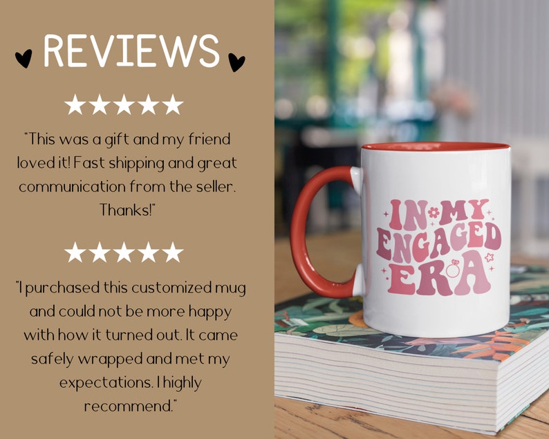 May include: White ceramic coffee mug with a red rim and handle. The mug has a pink and white graphic that says "In My Engaged Era" with a ring and stars. The mug is sitting on a stack of books.