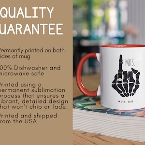 May include: White ceramic coffee mug with a red rim and handle. The mug features a black skeleton hand with a ring on the index finger and the text "MRS. EST. 2024".