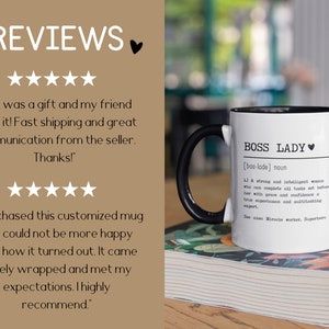 May include: White ceramic mug with a black handle. The mug has black text that reads "BOSS LADY [bos-lade] noun 1) A strong and intelligent woman who can complete all tasks set before her with grace and confidence. A true superhuman and multitasking expert. See also: Miracle worker, Superhero."