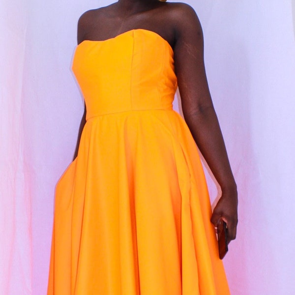 Bold Orange Tea Length Dress with Corset Top and Hidden Side Pockets. Ankle Length Maxi Dress for Formal Occasions.