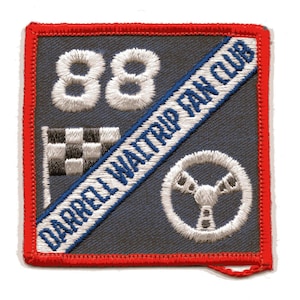 May include: Embroidered patch with a red border and a dark gray background. Features the number 88, a checkered flag, a steering wheel, and the text "DARRELL WALTRIP FAN CLUB" in white and blue.