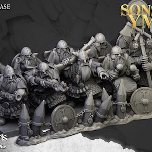 May include: A collection of grey miniature dwarf figures, each with detailed beards, helmets, and weapons, are displayed on a base. The image includes the text "JULY RELEASE" and the title "SONS OF YMIR".