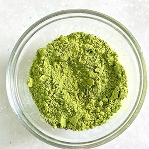 A matcha bowl filled with a heaping amount of bright green matcha