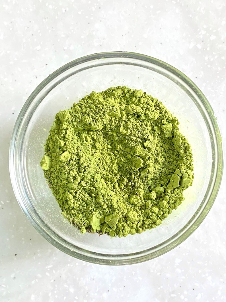 A matcha bowl filled with a heaping amount of bright green matcha