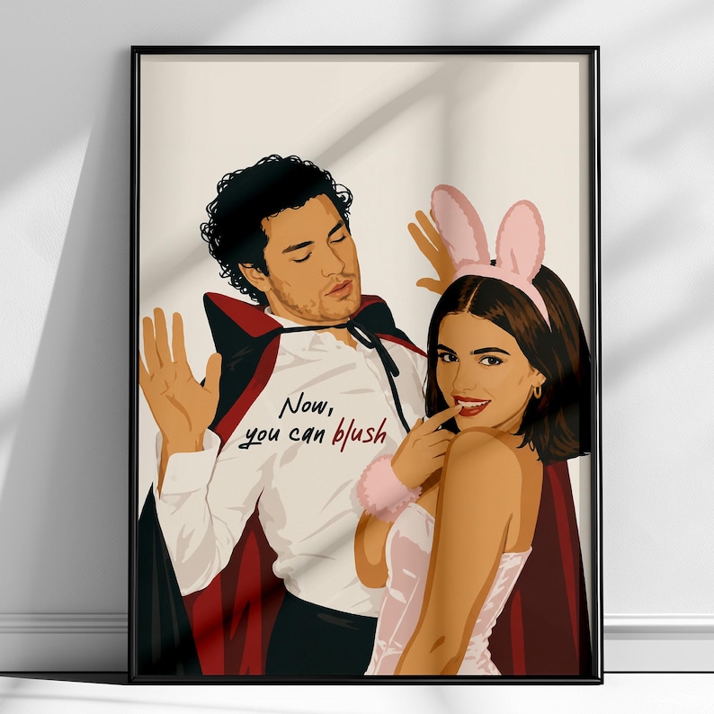 Stylized digital wall art featuring a romantic college couple inspired by a popular sports romance book series. The artwork shows a dark-haired male character dressed in a playful vampire costume beside a smiling female character wearing pink bunny ears. The illustration includes the quote "Now, you can blush" and is rendered in a modern minimalist portrait style with clean lines and soft colors. Perfect for romance readers, book lovers, and contemporary literary-inspired home decor.