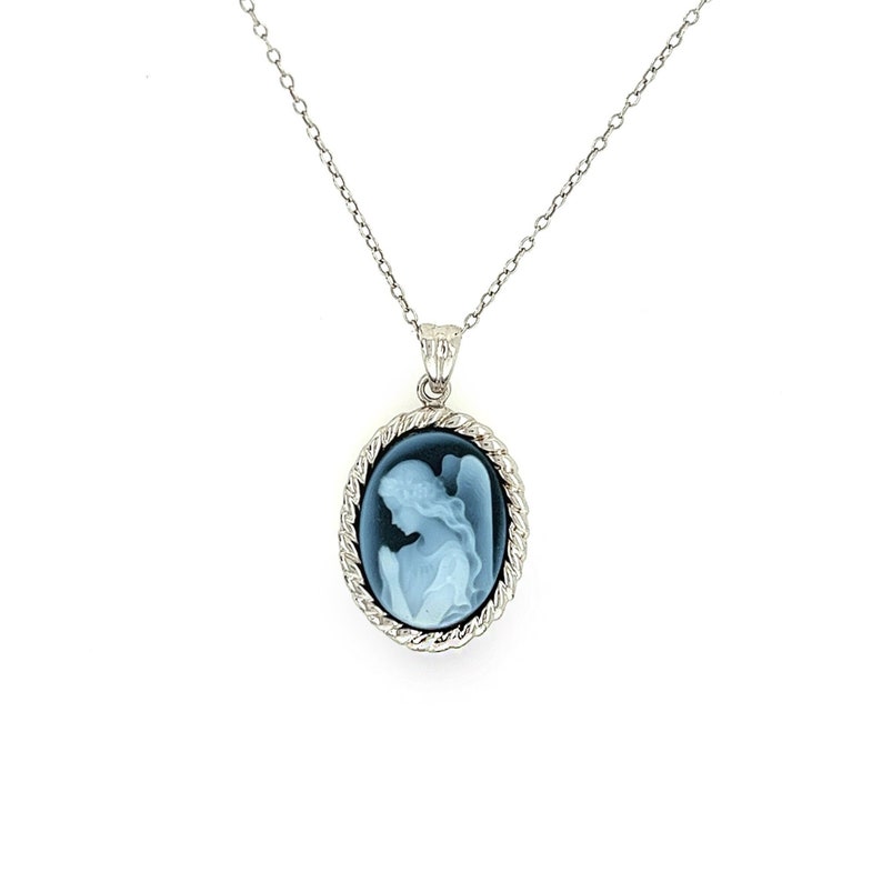 May include: A silver chain necklace with a blue cameo pendant featuring a white cameo of a praying angel.