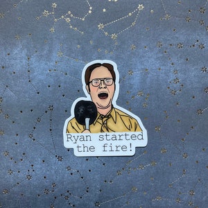 May include: A sticker featuring a cartoon illustration of a man with glasses holding a spatula and the text "Ryan started the fire!"