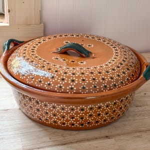 May include: A set of three ceramic mugs with a speckled, matte finish. The mugs are in shades of cream, light gray, and dark gray. Each mug has a simple, minimalist design, perfect for coffee or tea.