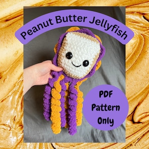 May include: Crochet pattern for a peanut butter and jelly-themed jellyfish. The jellyfish is made with purple and yellow yarn and has a smiling face. The pattern is available as a PDF download.