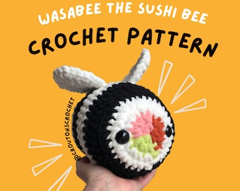 May include: Crochet pattern for a Wasabbee the Sushi Bee amigurumi toy. The bee is black, white and pink with a green and pink sushi roll face. The pattern is available on @croutonscrochet.