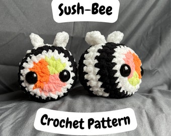 May include: Two crocheted bee plushies, one black and white with orange and green accents, the other black and white with pink and yellow accents. The plushies are sitting on a gray surface. The text "Sush-Bee Crochet Pattern" is written in white on a black background.