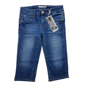 May include: Blue denim shorts with a gold button and a small tag attached to the right side.