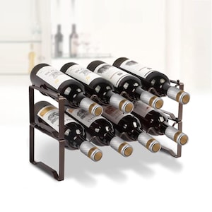 May include: A bronze metal wine rack holding nine bottles of red wine. The bottles are arranged in two rows, with the labels visible. The rack has a simple, geometric design, suitable for a kitchen or dining room.