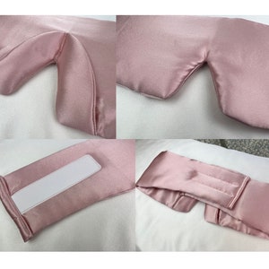 pink silk eye mask showing the different features including padded nose area and white velcro adjustable strap