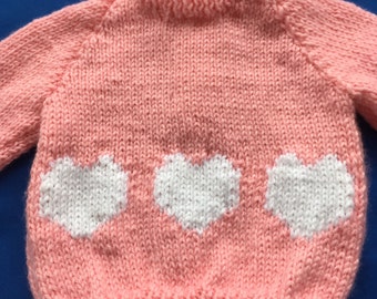 Hand knitted child’s cardigan with hearts